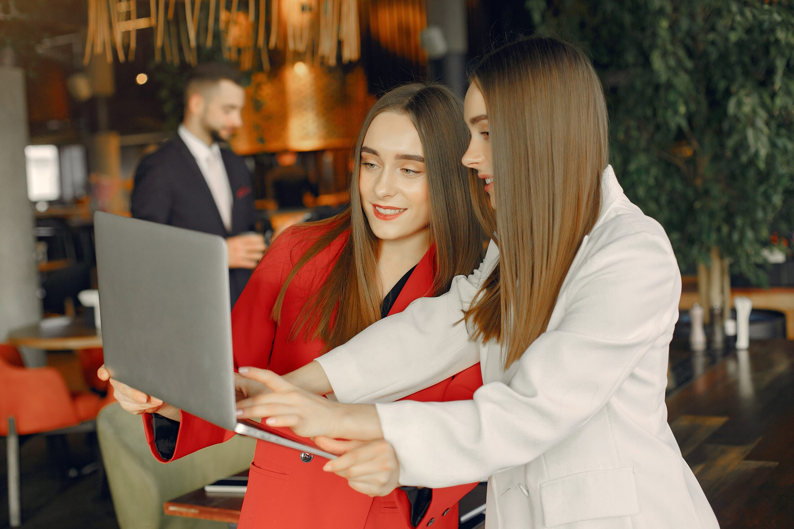 Two businesswomen working in a cafe - Bidaya Global