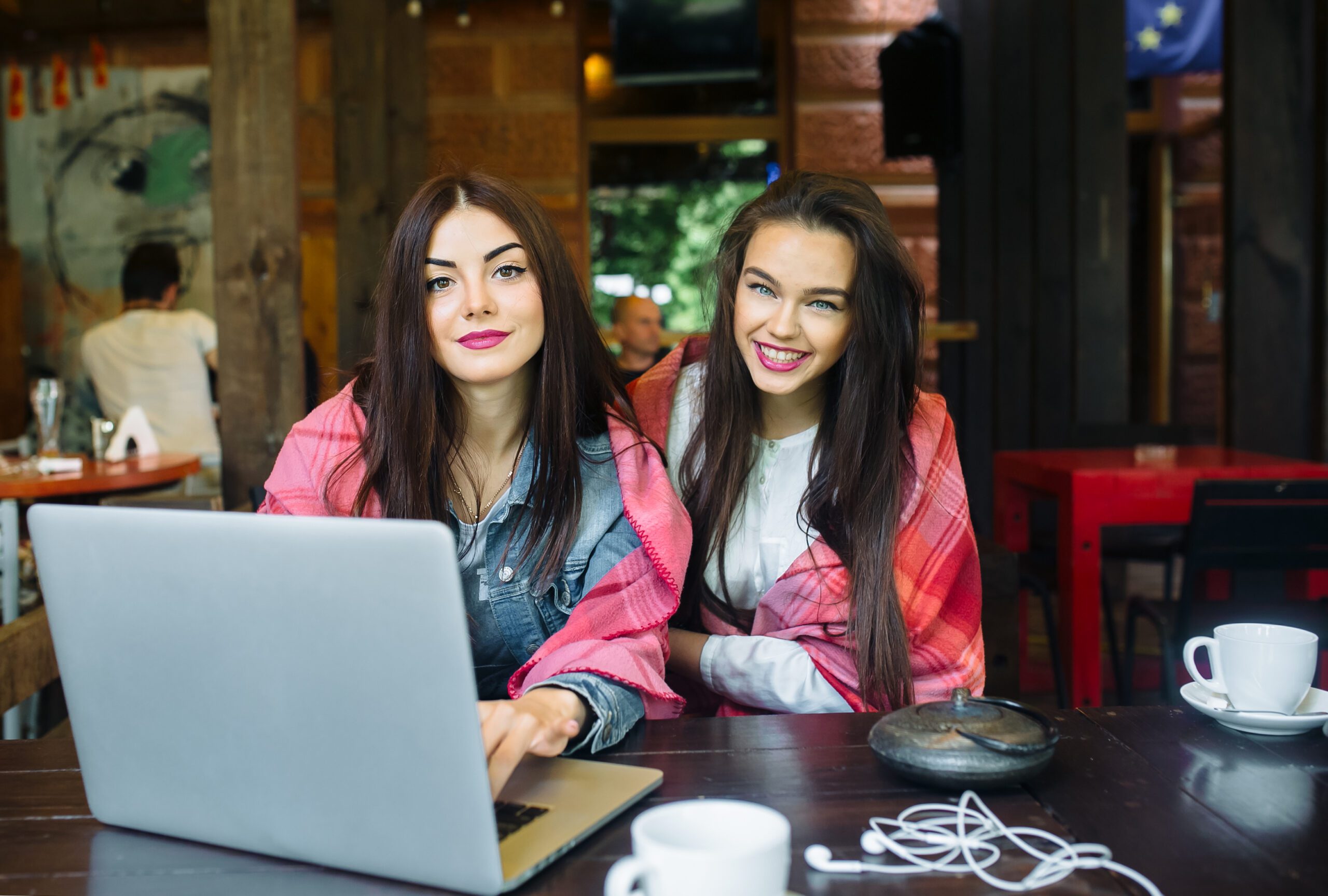 two girls watching something in laptop - Bidaya Global